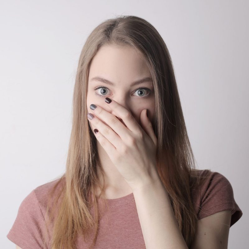 young-amazed-woman-in-casual-wear-covering-mouth-while-3885603-scaled